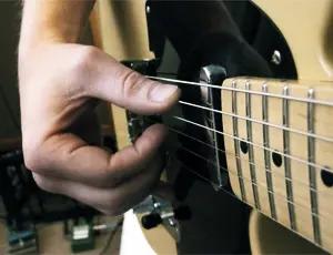 Right-hand fingerpicking on electric guitar using fingertips instead of a pick