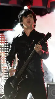 Electric guitarist playing while standing with a guitar strap