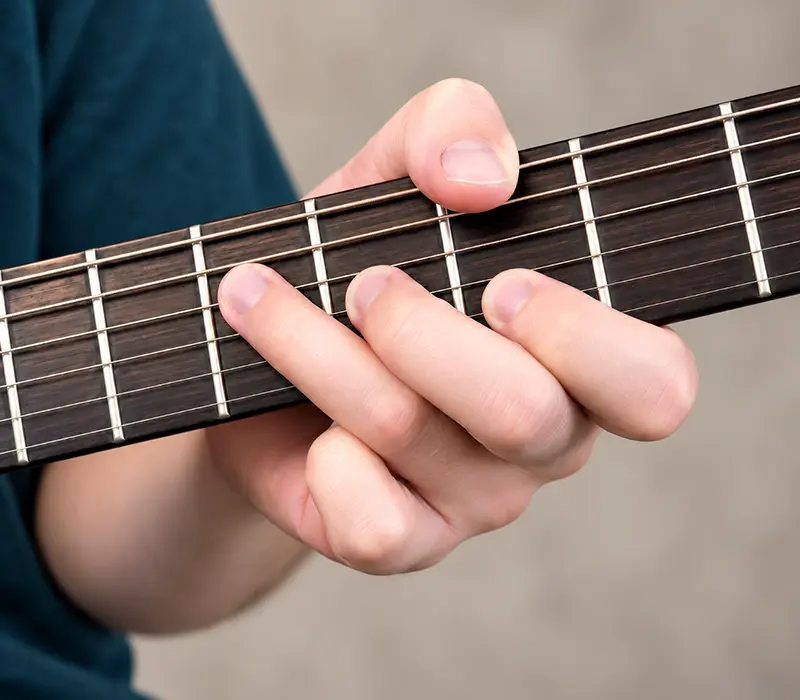 Jimi Hendrix thumb-over chord technique on guitar