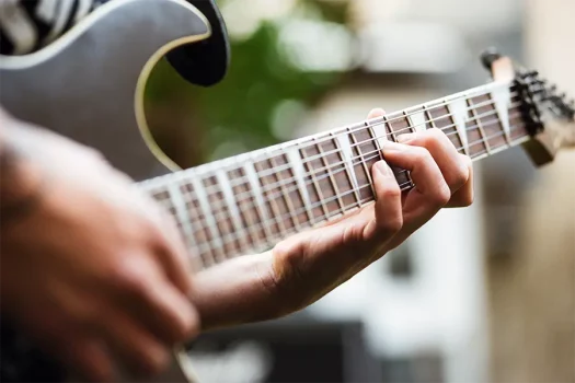Electric guitar strings on the fretboard of an electric guitar