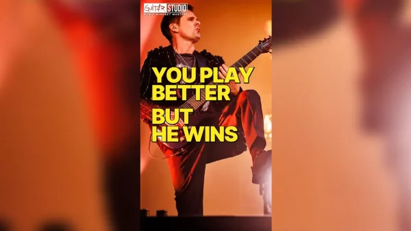 Matt Bellamy playing guitar with intense expression, highlighting his unconventional technique and unique musical style.